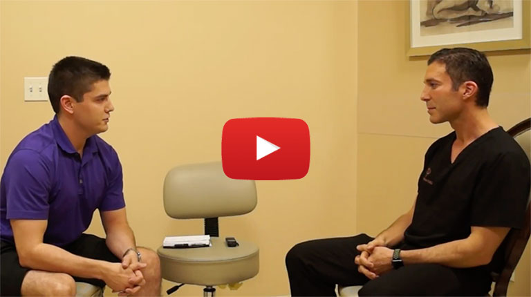 Dr. Prichard consulting a male patient in an exam room